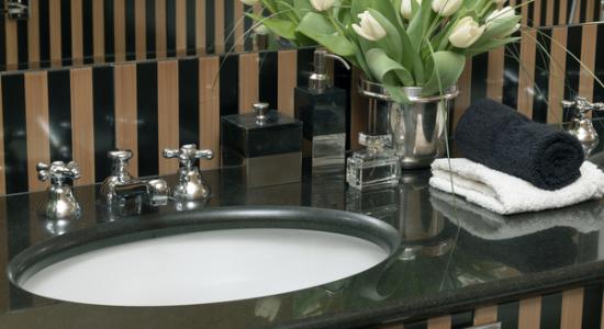 Luxury Cloak Room with Black Stone Worktop. 